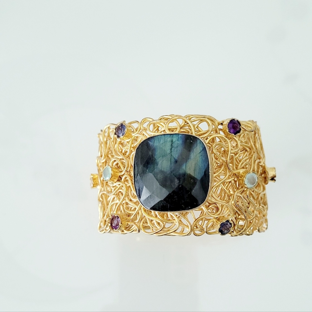 Gold tone filigree bracelet with multicolored  stones
